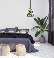 Trestle 1 Light 8" Pendant in Matte Black + Olde Brass in a room setting