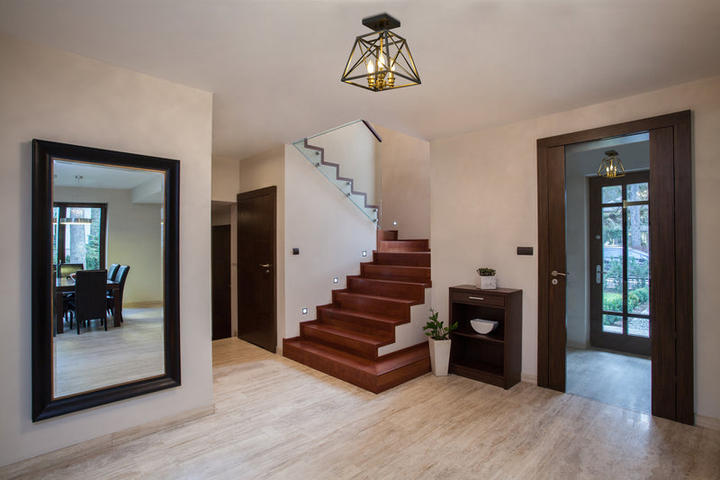 Trestle 3 Light 11" Semi Flush Mount in Matte Black + Olde Brass in a room setting