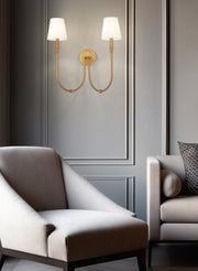 Jisele 2 Light 20" Wall Sconce in Rubbed Brass in a room setting