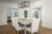 Euclid 8 Light 44" Linear Pendant in Matte Black in a room setting