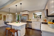 Kraken 5 Light 25" Chandelier in Matte Black + Olde Brass in a room setting