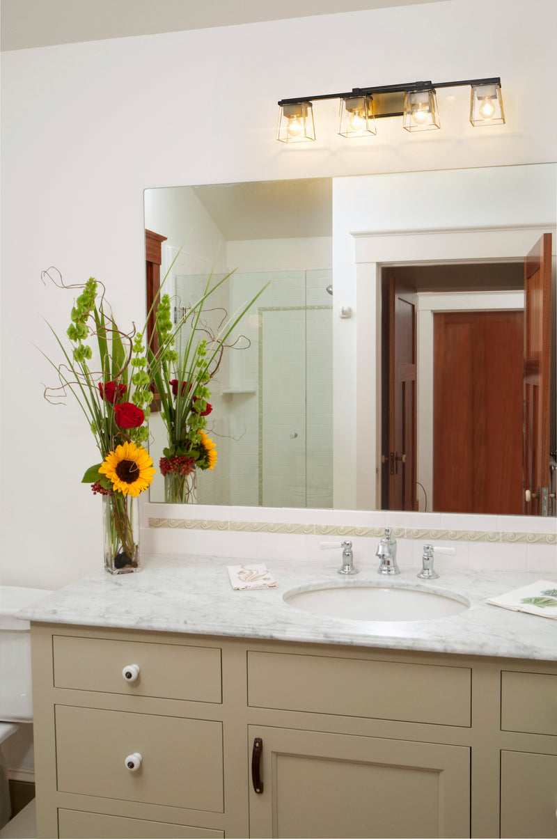 Bleeker Street 4 Light 33" Vanity in Matte Black + Olde Brass in a room setting