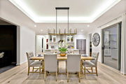 Haylie 12 Light 56" Linear Pendant in Matte Black + Olde Brass in a room setting