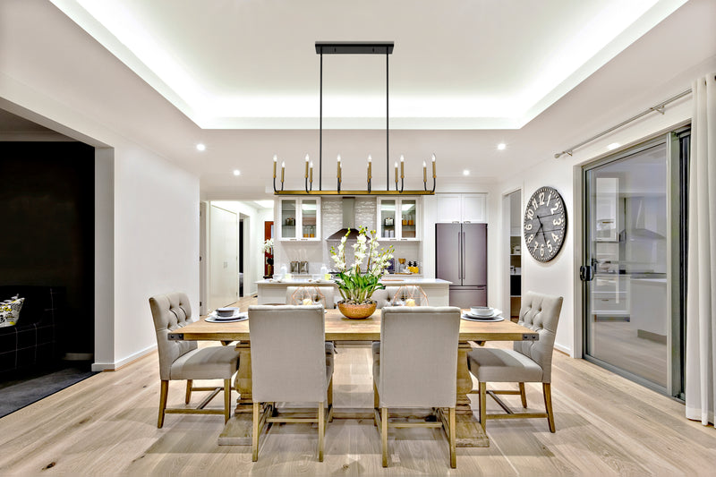 Haylie 12 Light 56" Linear Pendant in Matte Black + Olde Brass in a room setting