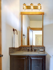 Beckett 3 Light 23" Vanity in Olde Brass in a room setting
