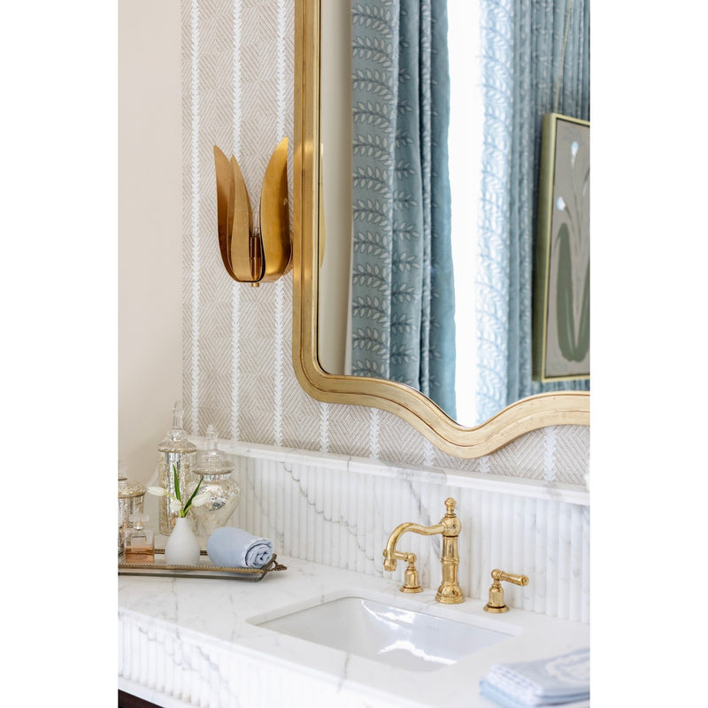 Broche 1 Light 8" Sconce in Antique Gold in a room setting