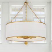 Broche 8 Light 29" Chandelier in Antique Gold in a room setting