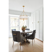 Broche 6 Light 24" Chandelier in Antique Gold in a room setting