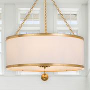 Broche 6 Light 24" Chandelier in Antique Gold in a room setting