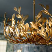 Broche 6 Light 27" Chandelier in Antique Gold in a room setting