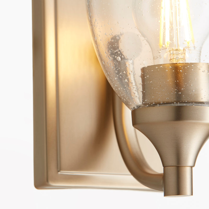 Enclave 1 Light Clear Seeded Wall Sconce in Aged Brass