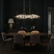 Broche 6 Light 50.5" Linear Chandelier in Antique Silver in a room setting