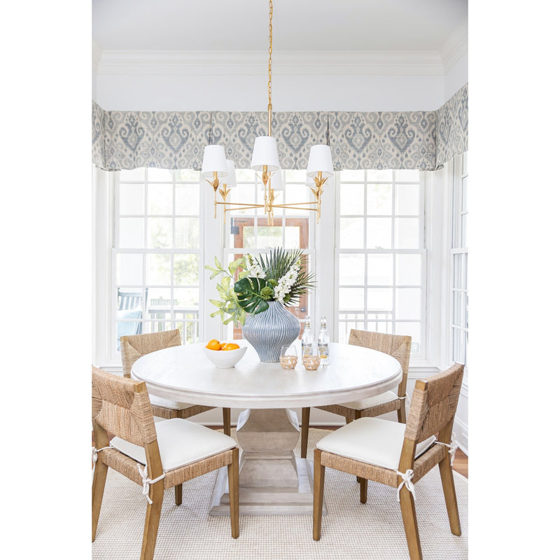 Broche 6 Light 32" Chandelier in Antique Gold in a room setting