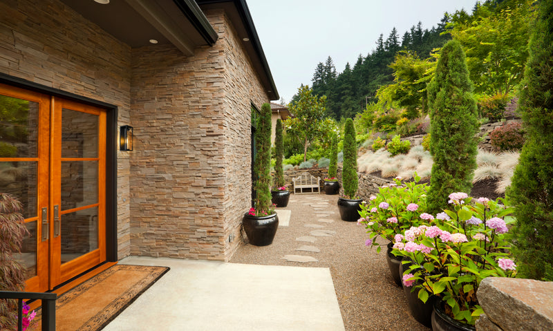 Dunbroch 1 Light 8" Outdoor Wall Light, 18.25" Tall in Deep Bronze + Outdoor Brass in a room setting