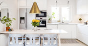 Eaton 1 Light 24" Pendant in Rubbed Brass in a room setting