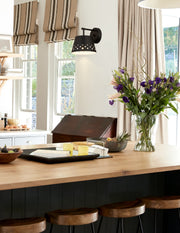 Katie 1 Light 8" Wall Sconce in Matte Black in a room setting