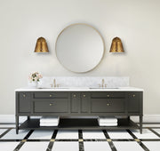 Katie 1 Light 8" Wall Sconce in Rubbed Brass in a room setting