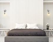 Neutra 1 Light 6" Wall Sconce in Matte Black + Polished Nickel in a room setting
