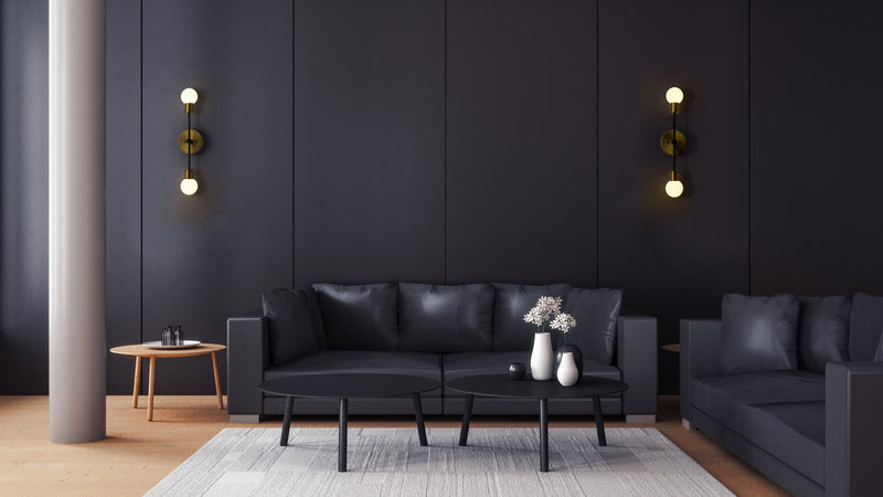 Neutra 2 Light 6" Wall Sconce in Matte Black + Foundry Brass in a room setting