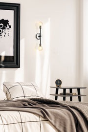 Neutra 2 Light 6" Wall Sconce in Matte Black + Polished Nickel in a room setting