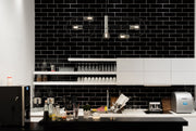 Neutra 5 Light 44" Linear Pendant in Matte Black + Polished Nickel in a room setting