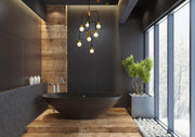 Neutra 7 Light 22.5" Chandelier in Matte Black + Foundry Brass in a room setting