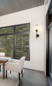 Arden 1 Light 4.5" Wall Sconce in Matte Black in a room setting