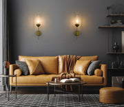 Arden 1 Light 4.5" Wall Sconce in Rubbed Brass in a room setting