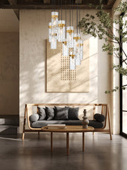 Fontaine 11 Light 26.25" Pendant in Rubbed Brass in a room setting