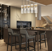Fontaine 5 Light 44.25" Linear Pendant in Rubbed Brass in a room setting