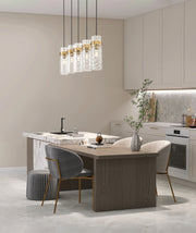 Fontaine 5 Light 44.25" Linear Pendant in Rubbed Brass in a room setting