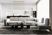 Fontaine 7 Light 56.75" Linear Pendant in Rubbed Brass in a room setting