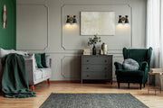 Soriano 2 Light 12" Wall Sconce in Matte Black + Heritage Brass in a room setting