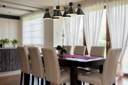 Soriano 6 Light 48" Linear Pendant in Matte Black + Heritage Brass in a room setting