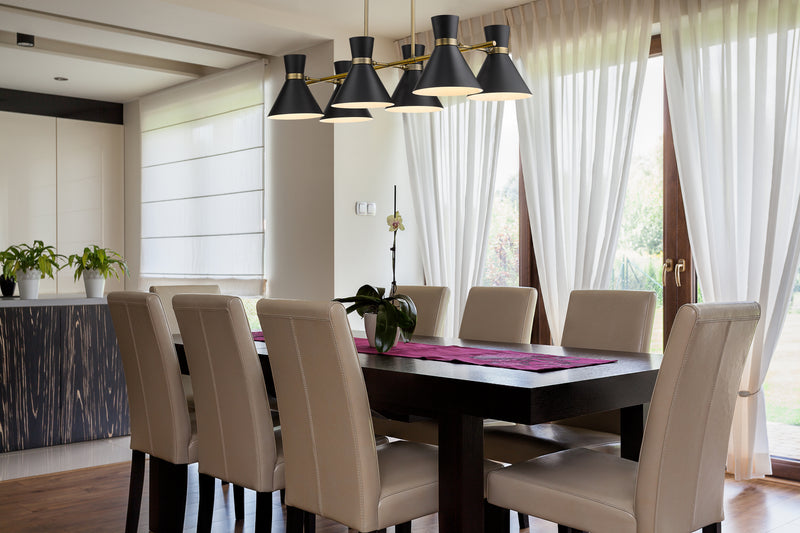 Soriano 6 Light 48" Linear Pendant in Matte Black + Heritage Brass in a room setting