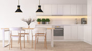 Soriano 1 Light 13.25" Pendant in Matte Black + Heritage Brass in a room setting