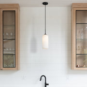 Monty 1 Light 5.25" Pendant, 17" Tall in Matte Black in a room setting