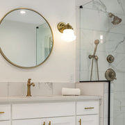 Vaughn 1 Light 6" Wall Sconce in Luxe Gold in a room setting