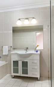 Vaughn 3 Light 22.5" Vanity in Brushed Nickel in a room setting
