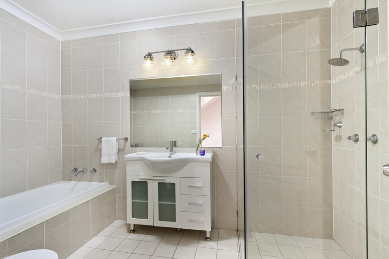 Vaughn 3 Light 22.5" Vanity in Brushed Nickel in a room setting
