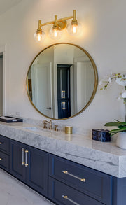 Sutton 3 Light 23.75" Vanity in Brushed Gold in a room setting