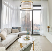Carnaby 9 Light 32.25" Pendant in Modern Gold in a room setting
