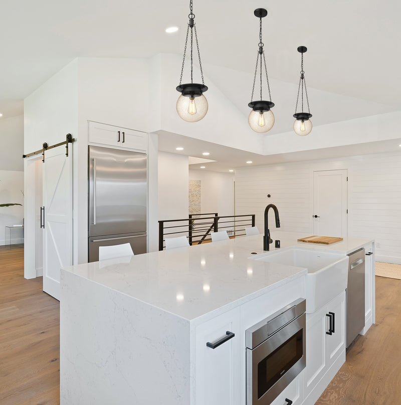Calhoun 1 Light 9" Pendant in Matte black in a room setting