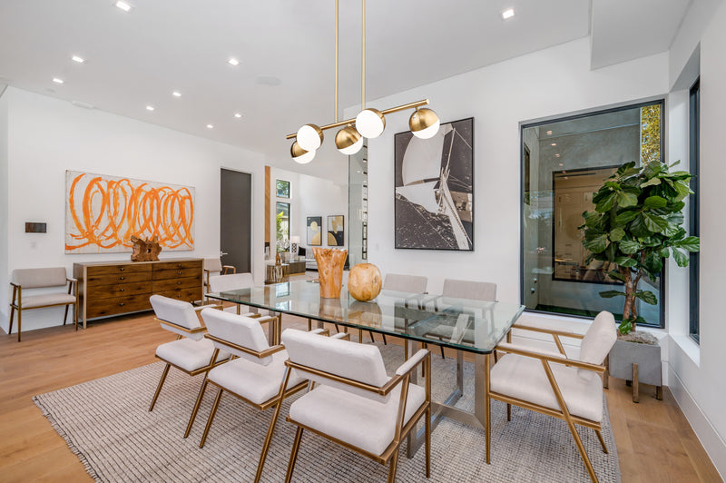 Realm Sphere 5 Light 42" Linear Pendant in Modern Gold in a room setting