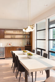 Realm Sphere 7 Light 54" Linear Pendant in Modern Gold in a room setting