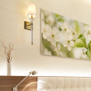 Ava 1 Light 5.5" Wall Sconce in Rubbed Brass in a room setting