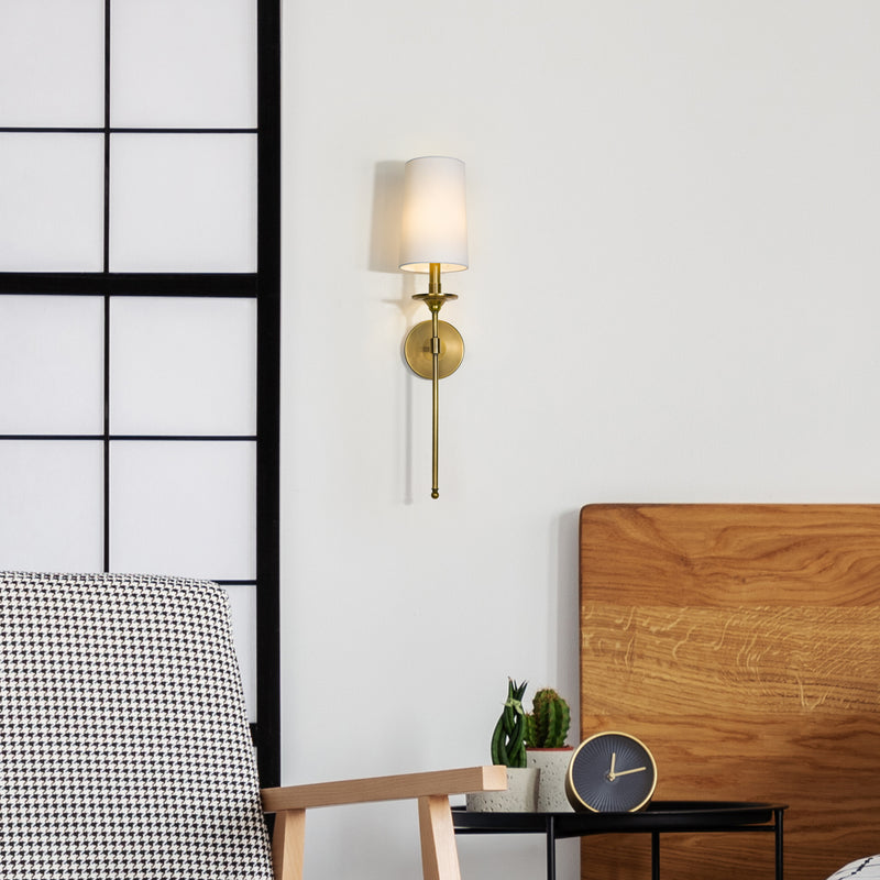 Emily 1 Light 5.5" Wall Sconce, 26" Tall in Rubbed Brass in a room setting