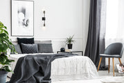 Calumet 2 Light 4.5" Wall Sconce in Matte Black + Polished Nickel in a room setting