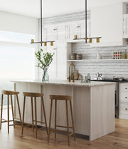 Calumet 3 Light 32" Linear Pendant in Matte Black + Olde Brass in a room setting