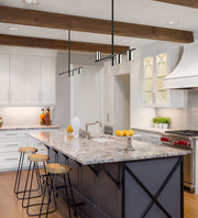 Calumet 3 Light 32" Linear Pendant in Matte Black + Polished Nickel in a room setting